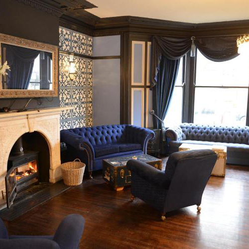 Interior lounge space of Townhouse Hotel with elegant navy sofas